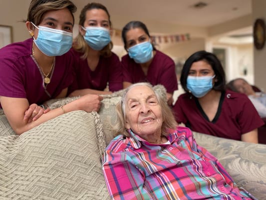 Residents and staff posing together in a common area