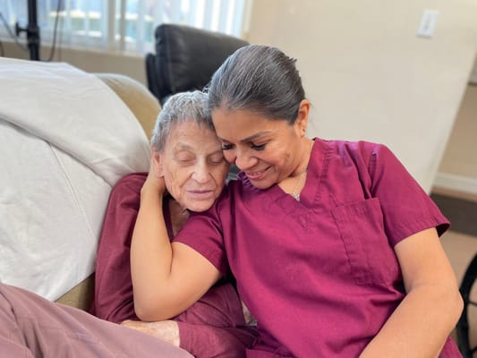 Caregiver and resident sharing a warm moment