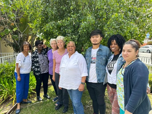 Group of staff and residents in a garden setting