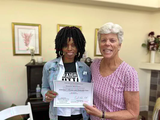 Staff member presenting a certificate to a resident