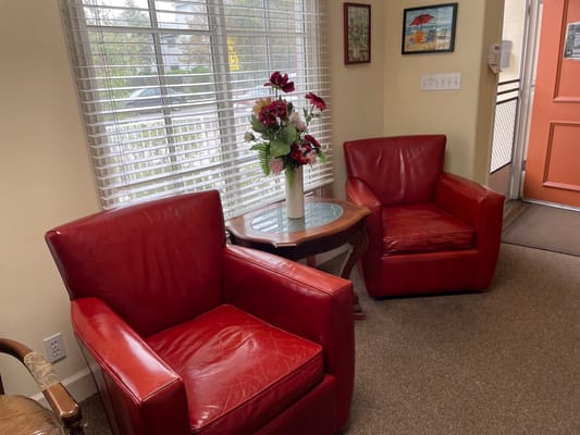 Cozy seating area with red chairs and a table