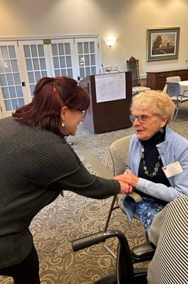 Staff engaging warmly with a resident in a common area