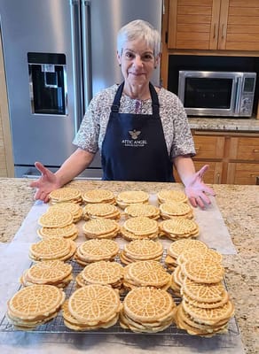 Staff member presenting homemade waffles in the kitchen