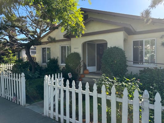 Exterior view of the residential care home with a white picket fence