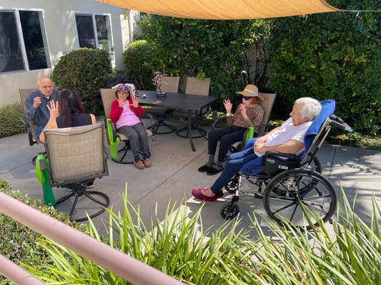 Residents enjoying conversation in an outdoor seating area