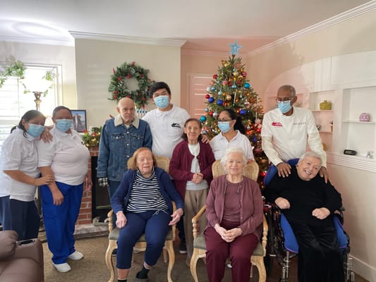 Residents and staff posing together for a holiday photo