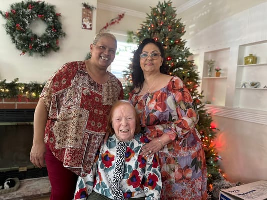Residents and staff celebrating together in a festive room