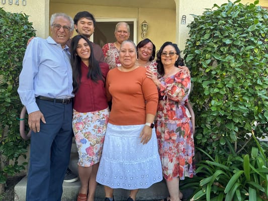 Residents and staff posing together at the entrance