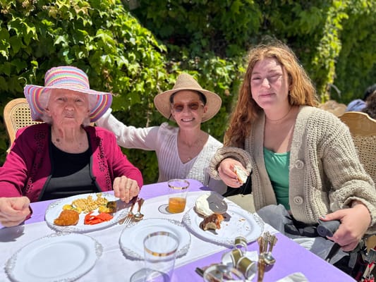 Residents enjoying lunch outdoors with family