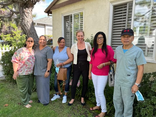 Staff and residents posing outside the facility
