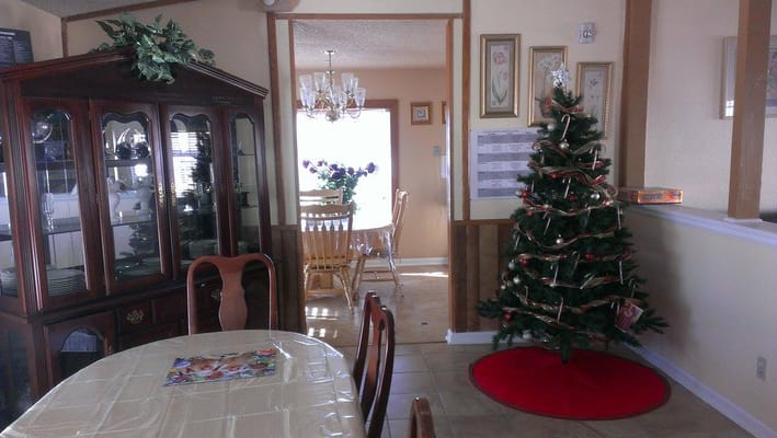 Decorated interior scene with Christmas tree and dining setup