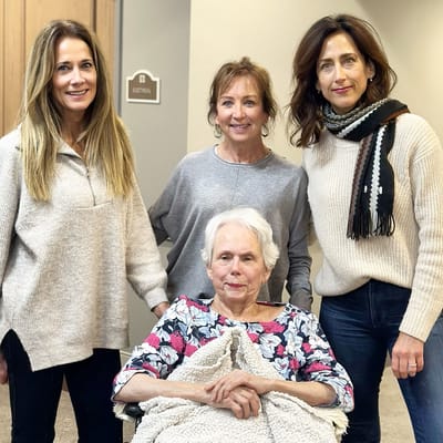 Residents and staff gathered in a cozy indoor space