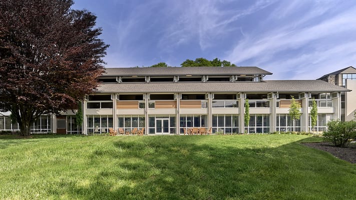 Exterior view of Cathedral Village building with landscaping