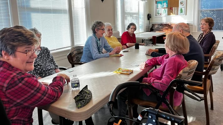 Residents engaged in a group activity around a table