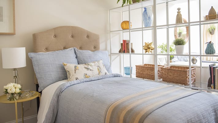 Cozy bedroom setup with light decor and bedding