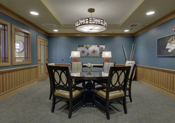 Bright common area with a round table and chairs
