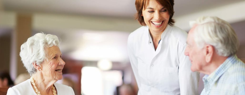 Caregiver assisting residents in a communal space