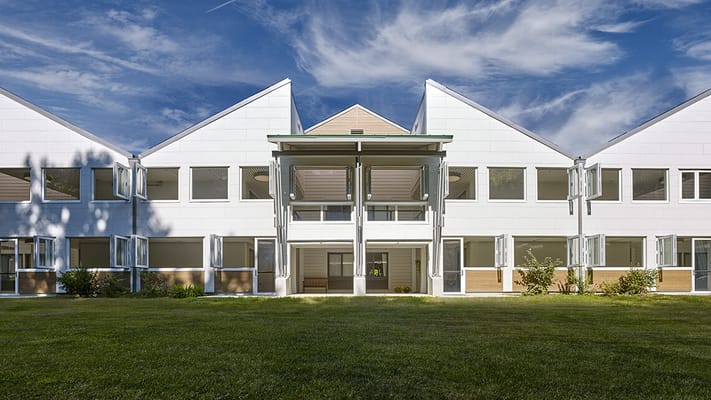 Building exterior of a senior living facility with a lawn
