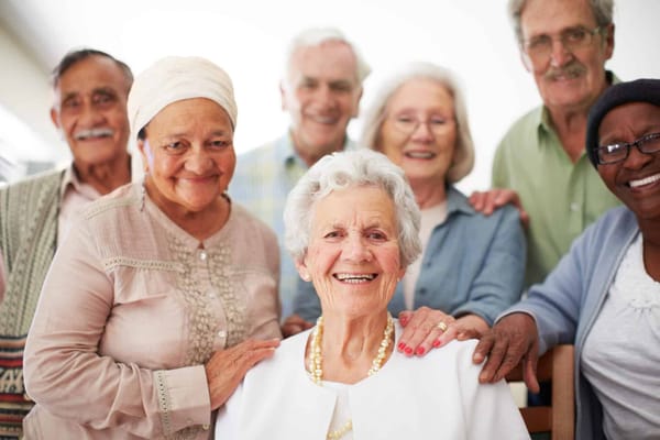 A group of smiling senior residents posing together