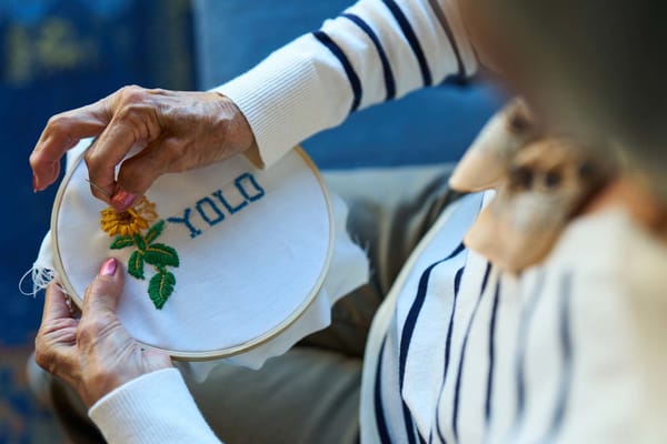A resident embroidery project with the word 'YOLO'