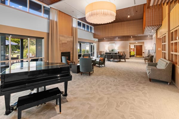 Bright common area with a piano and seating