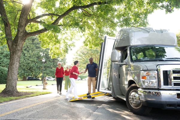 Residents using accessibility transport vehicle on a sunny day