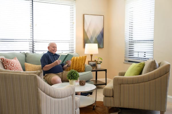 Resident reading in a cozy sitting area