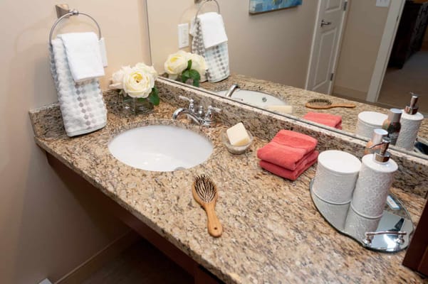 Well-decorated bathroom countertop with flowers and hygiene items