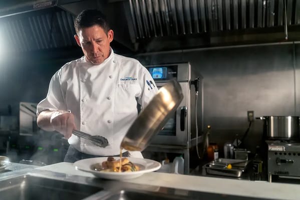 Chef preparing a gourmet meal in a kitchen