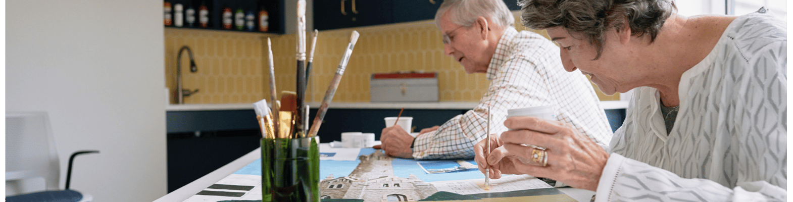 Two residents engaging in a creative activity indoors