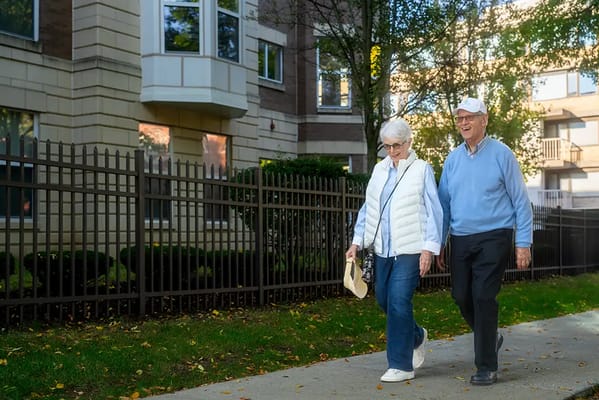 Senior couple walking outside the facility