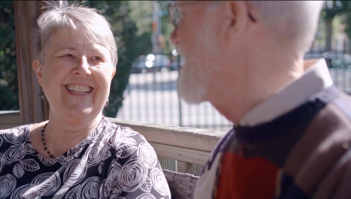 Two residents enjoying conversation outdoors