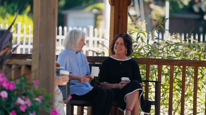 Residents enjoying coffee in a garden gazebo