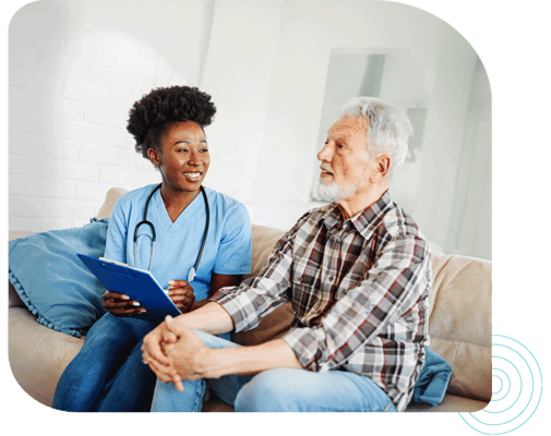 A caregiver speaking with a resident in a cozy setting