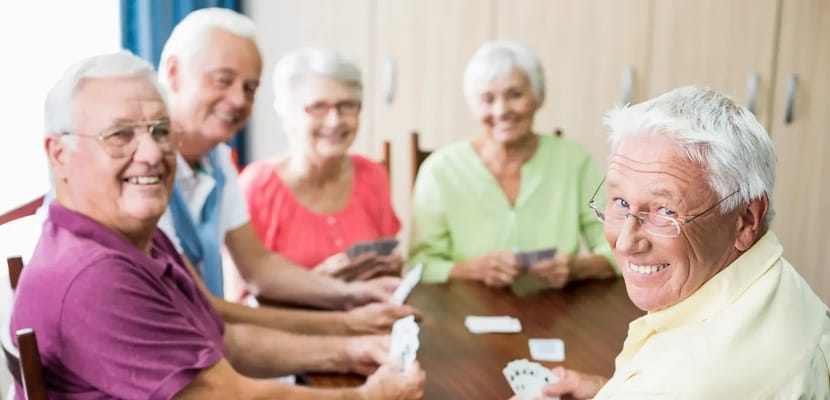 Residents playing cards in an activity room