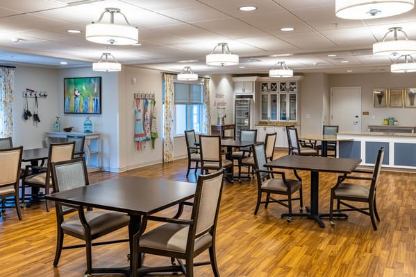 Common area with tables and chairs in a bright setting