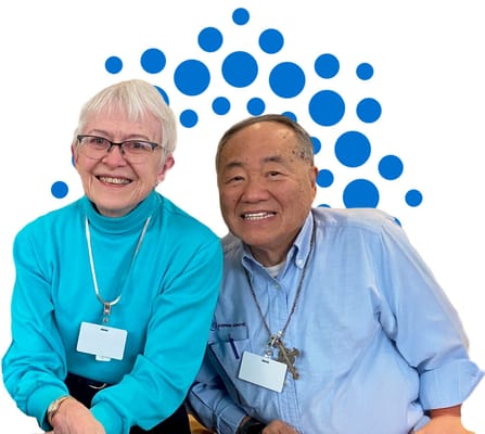 Two residents smiling together in a social setting