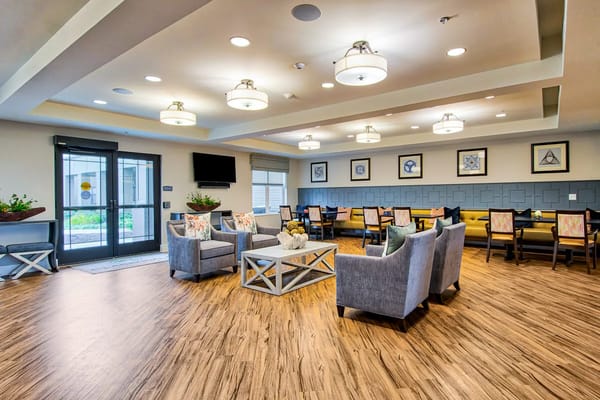 Bright common area with seating and dining tables