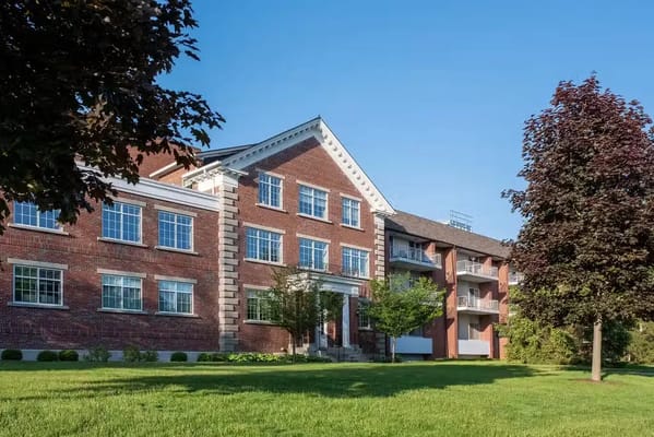 Exterior view of a senior living facility with landscaped grounds