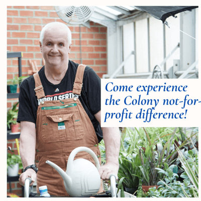 A resident gardening in a greenhouse at Colony III