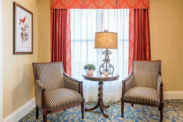 Cozy seating area with two chairs and a lamp