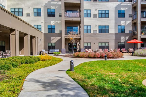Outdoor seating area and pathway in a senior living facility