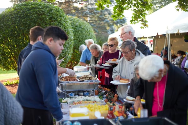 Residents enjoying a community outdoor meal event