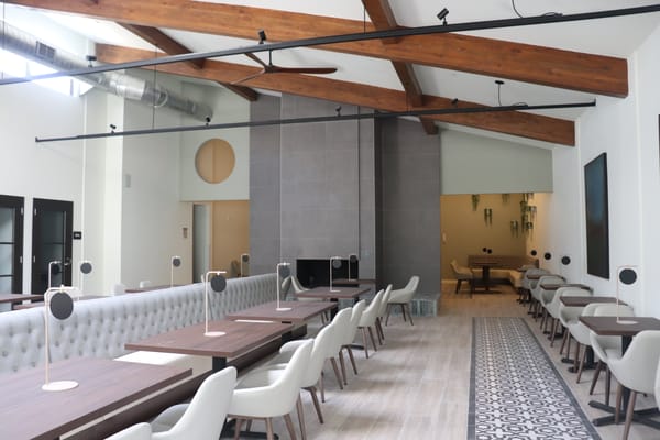 Bright and modern common area with dining tables and chairs