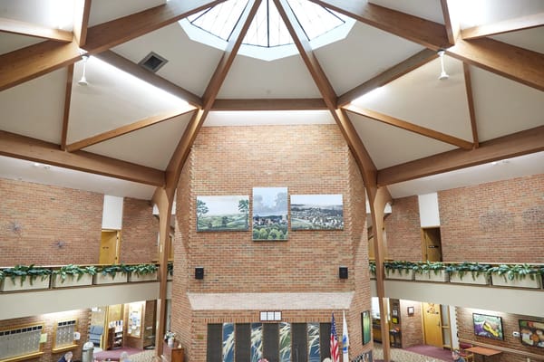 Interior view of a lobby with high ceilings and artwork