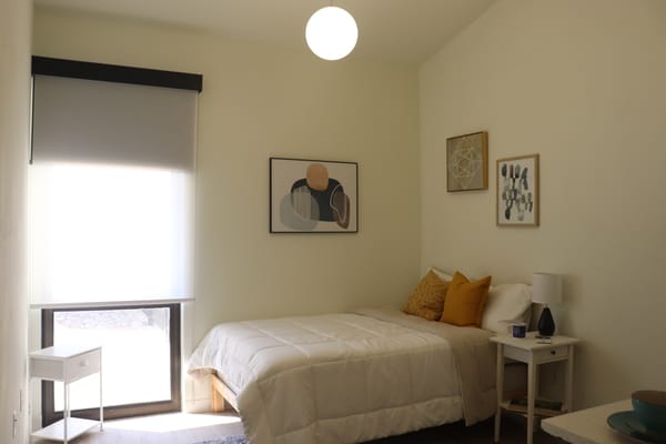 Cozy private room with a bed and artwork