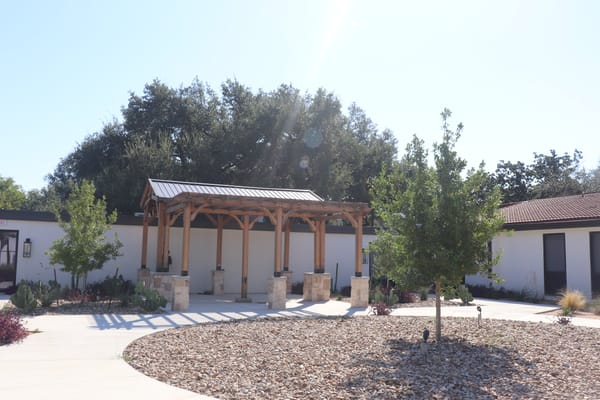 Outdoor seating area with shade structure and landscaping