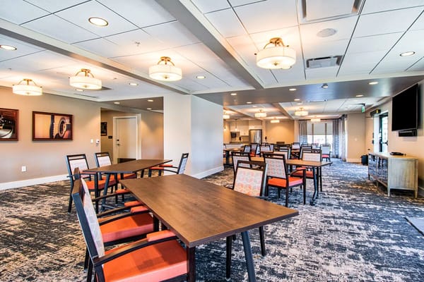 Bright dining area with empty tables and chairs