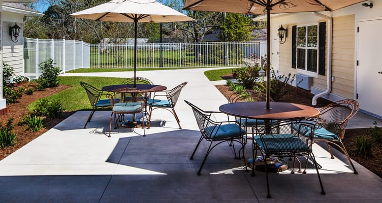 Outdoor seating area with shaded tables and chairs