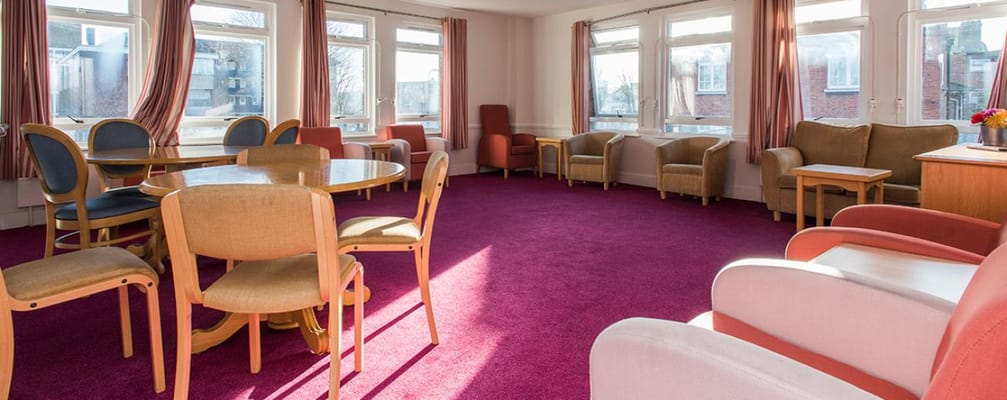 Bright common area with seating and tables